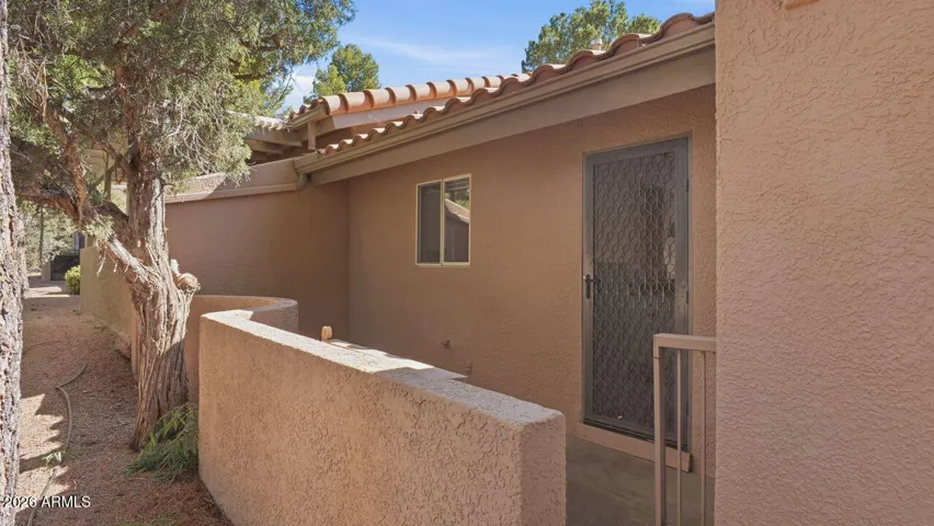 Rear patio with a security screen door entry from the kitchen.