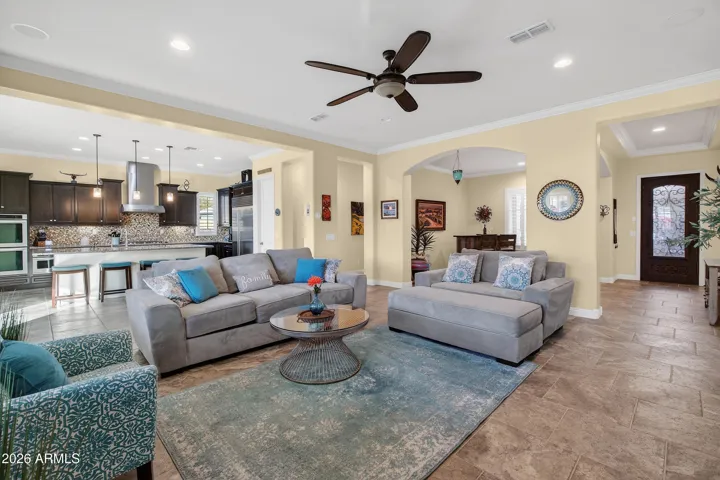 Open floorplan with high ceilings, ceiling speakers and crown molding.
