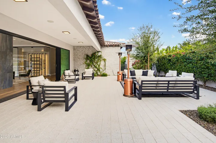 Front gated courtyard leading into living room w/sliding walls of glass