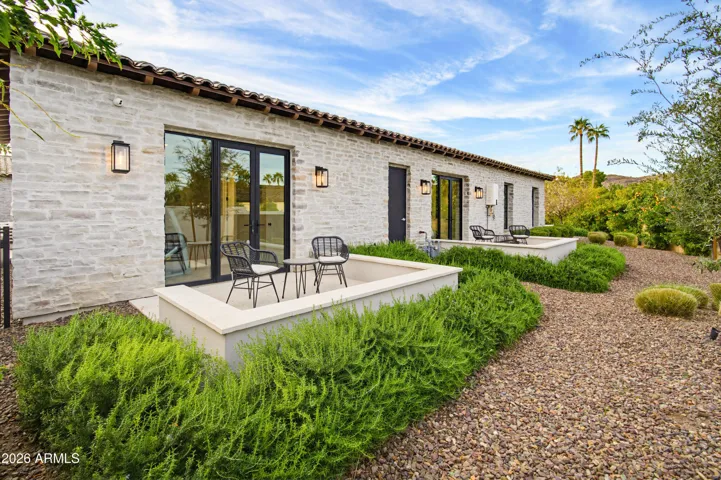 East side of home with guest bedroom patios
