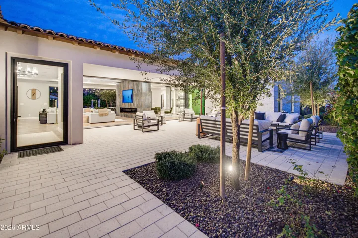Gated walled front courtyard with walls of glass open to living room