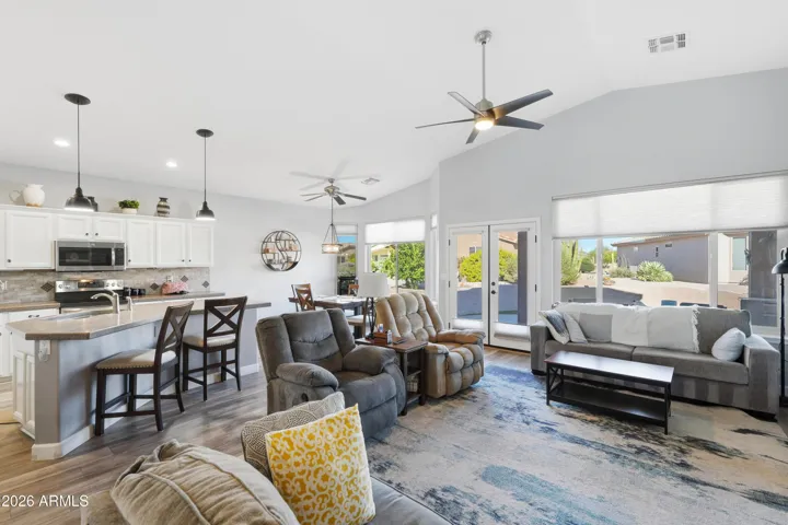 Neutral flooring throughout. French doors to the patio