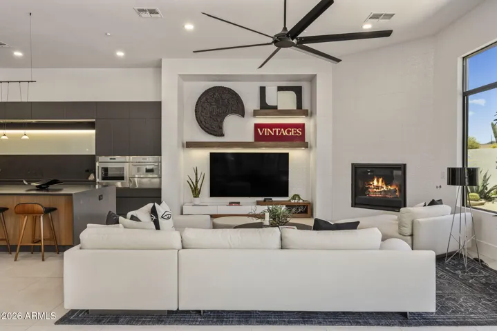 Floor-to-ceiling custom tile feature wall with floating shelves and integrated lighting