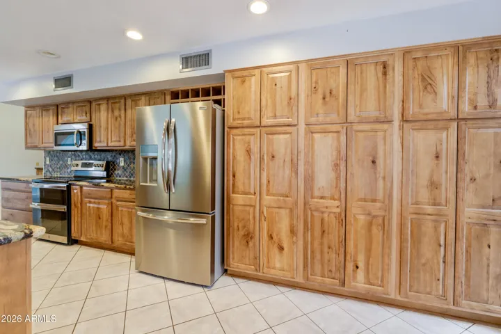 The kitchen with granite countertops and updated cabinetry..