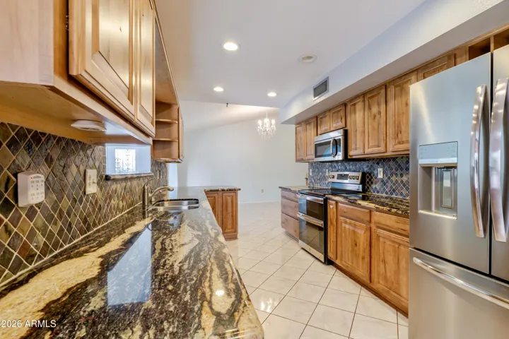 The kitchen with granite countertops and updated cabinetry..