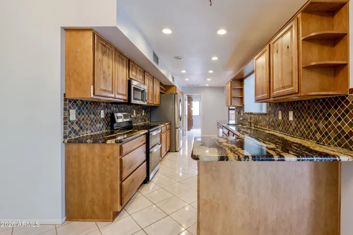 The kitchen with granite countertops and updated cabinetry..