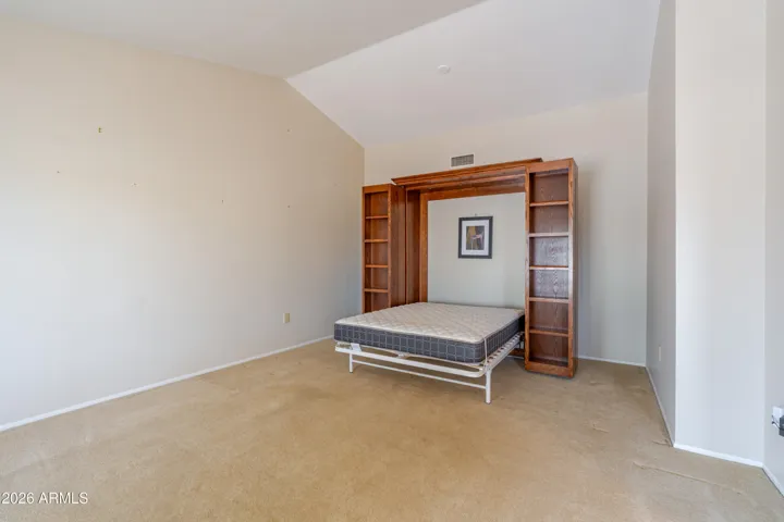 The living room with a Murphy Bed / Bookcase.