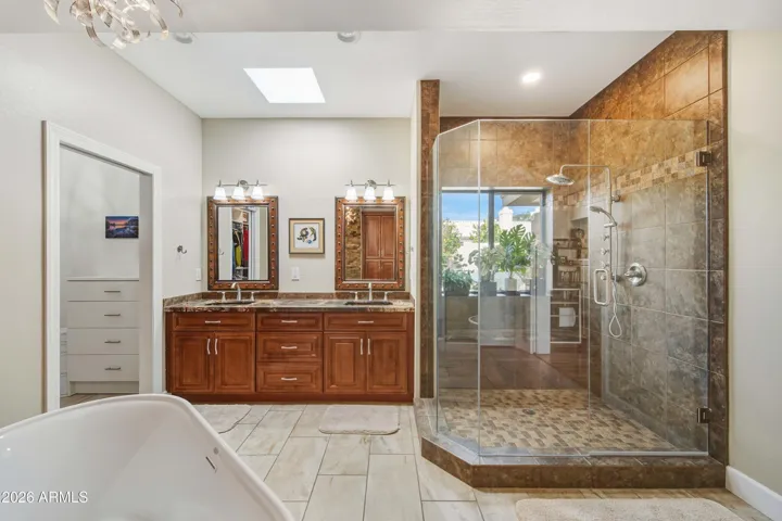 glass enclosed shower, dual sinks with light feature