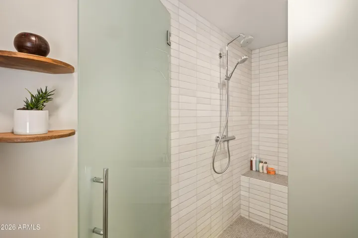 Newly installed frosted glass provides some privacy yet allows natural light in from the large primary bath window.