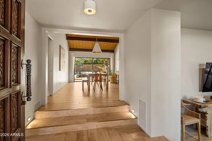 The refurbished original hand carved entry door opens into the hub of the home, living room, dining room, kitchen, and bedroom access radiate from this central hub.