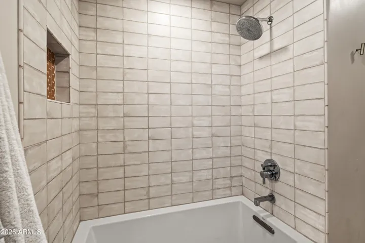 An extra deep Japanese inspired soaking tub make brings an elevated touch to the hall bath.