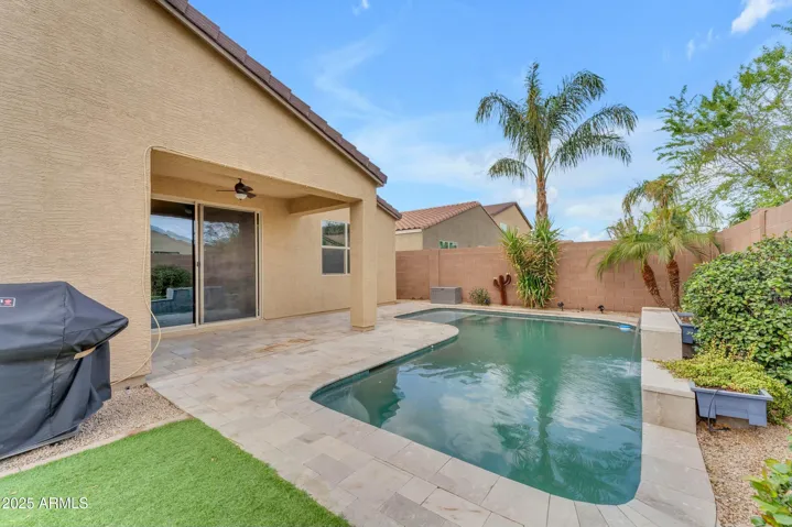 Pool with water feature, covered patio, travertine pavers!