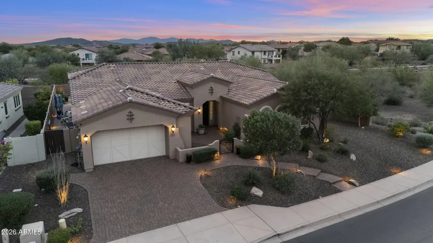 Mature desert landscaping, paver walkways, and upscale curb appeal in Blackstone golf community.