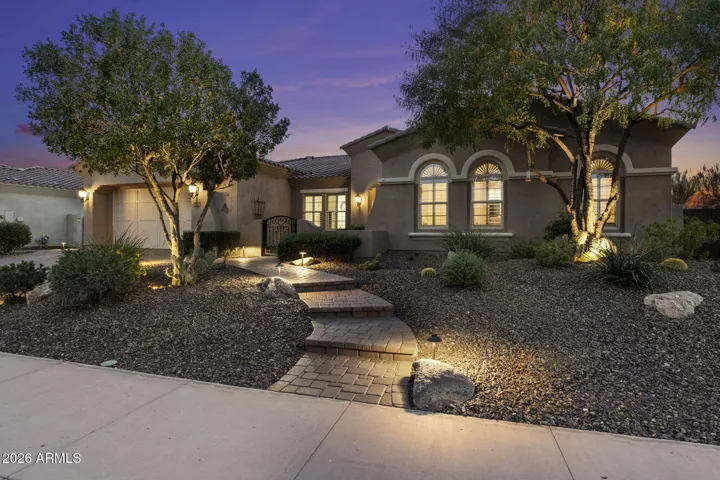 A luxury home in Blackstone at Vistancia, featuring paver driveway, desert landscaping, and elegant architectural details.