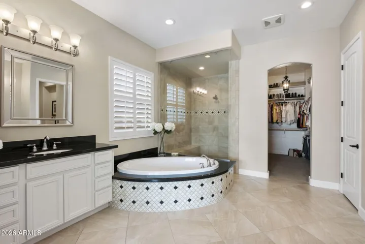 Primary bathroom with split vanities.