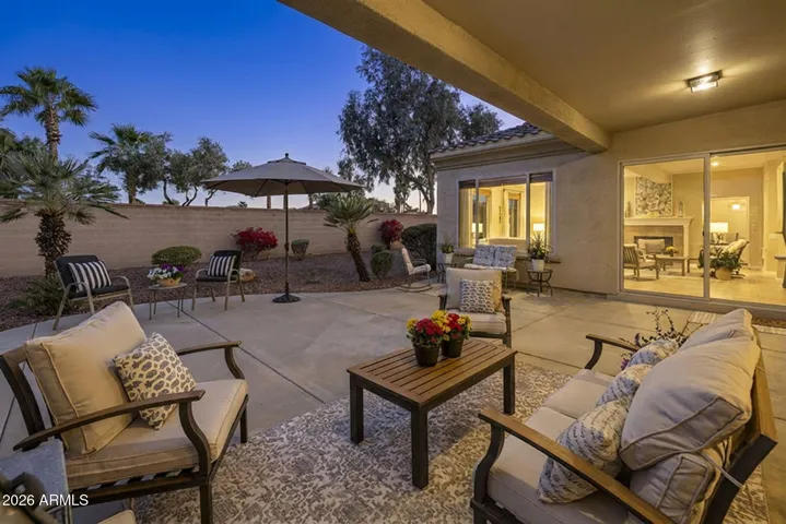 Open backyard with multiple seating and expansive patio.