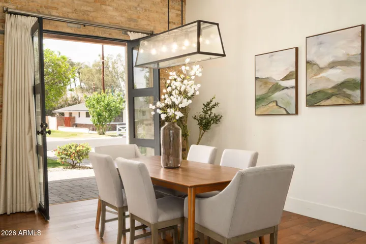 Brick accents and Iron and Glass French doors make this formal dining area extremely special.