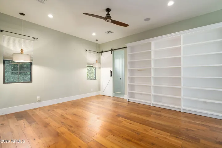 This home features a generous primary suite with custom built ins and backyard access.