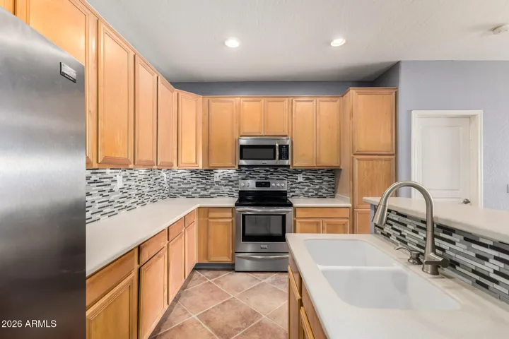 Kitchen includes SS apps-gas range, too! Quartz counters and tile backsplash!