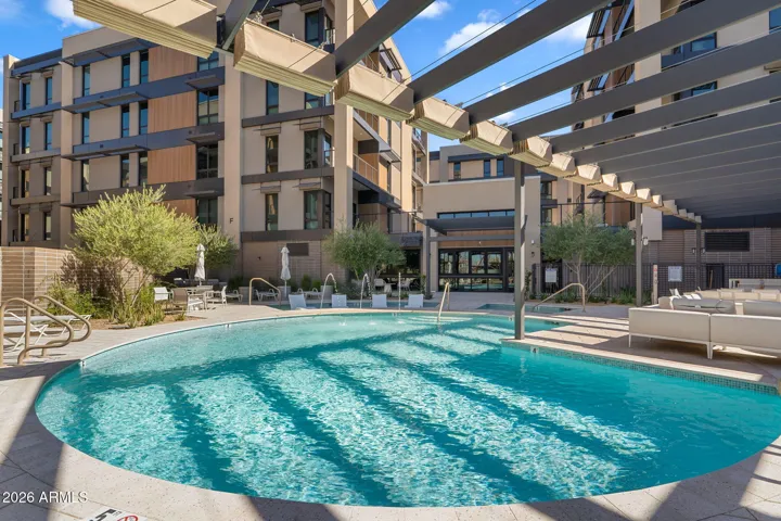 Resort-style pool surrounded by lounge areas.