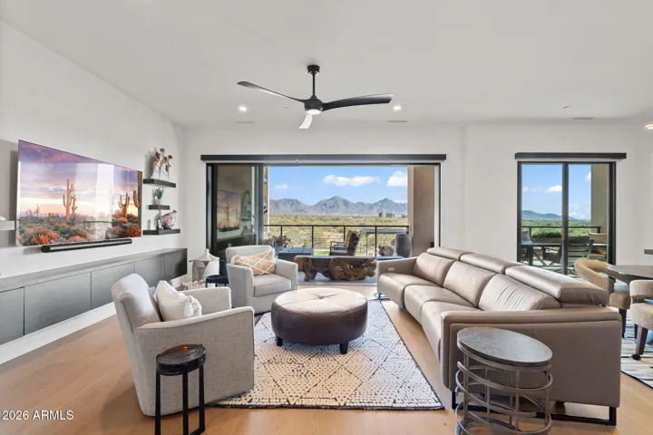 Light-filled open-concept great room with seamless flow to the terrace and expansive mountain views.