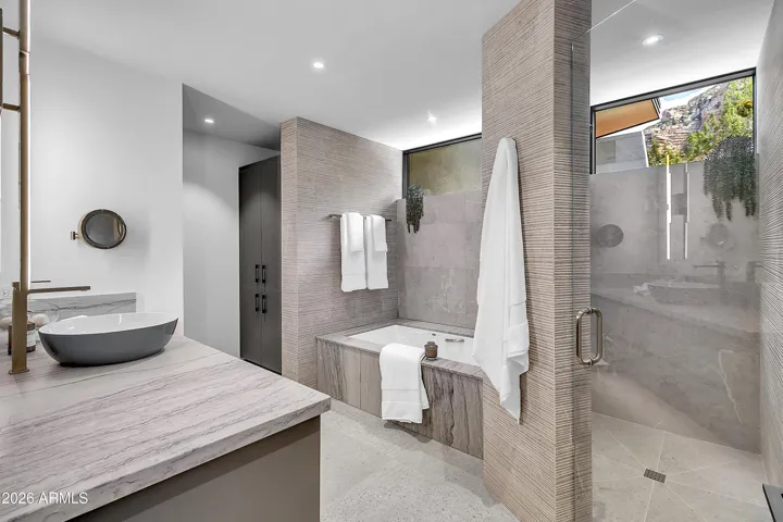 Guest ensuite separate tub/shower. Designer custom tile throughout. Granite counter tops.