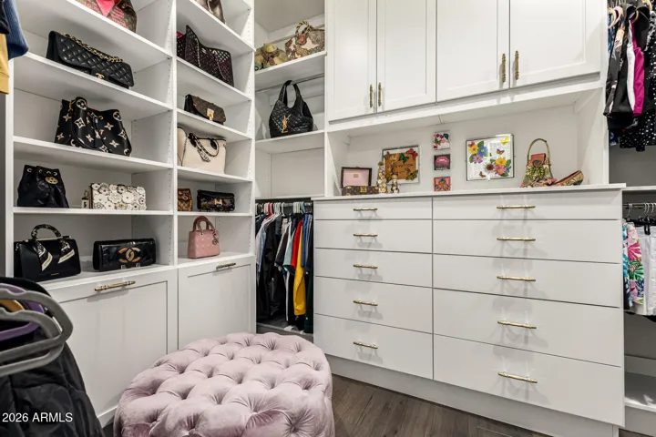 Custom closet organizers throughout.