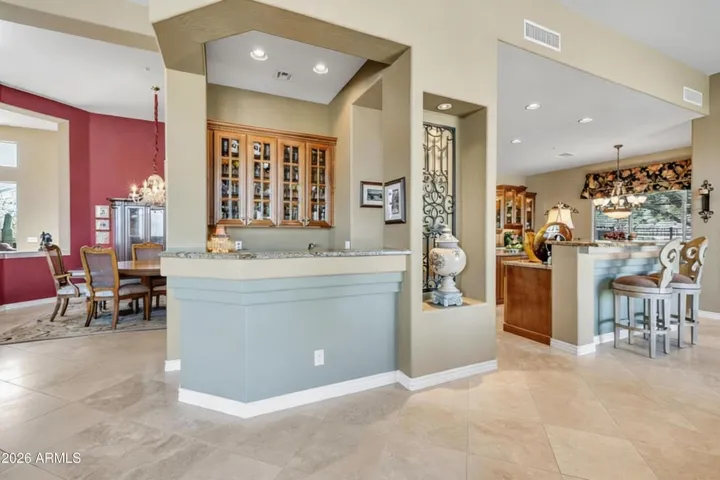 Wet bar opens to dining, living and family rooms.
