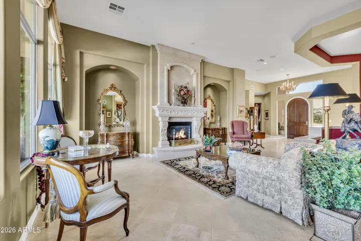 The front door/foyer opens to lovely living room space w/cantera fireplace
