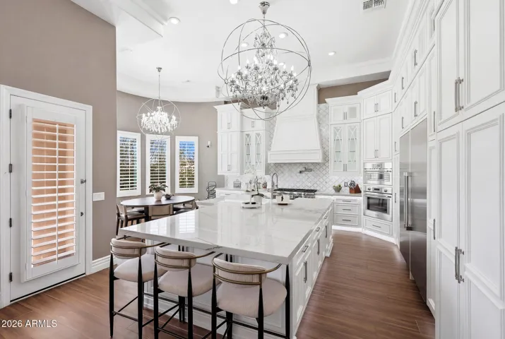 Remodeled kitchen with custom cabinetry, quartzite countertops, and large island