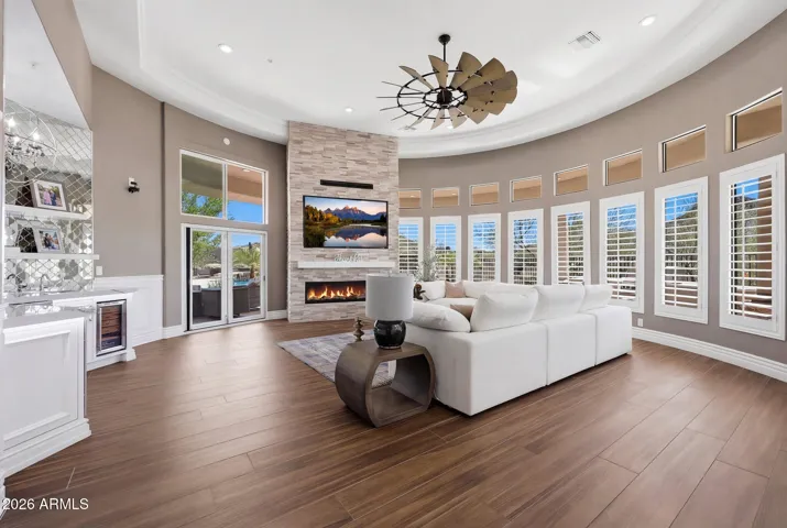 Light-filled family room with soaring ceilings and a wall of windows framing the outdoor views