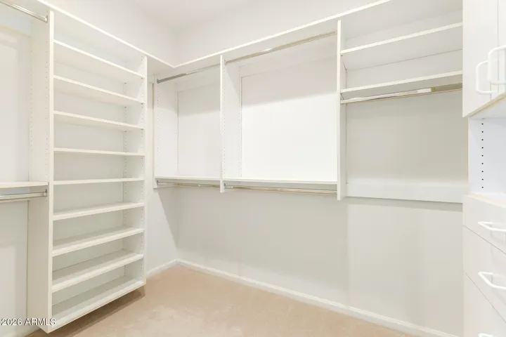 walk-in closet with built-in shelves and drawers