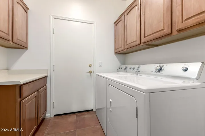 laundry room with extra storage cabinets