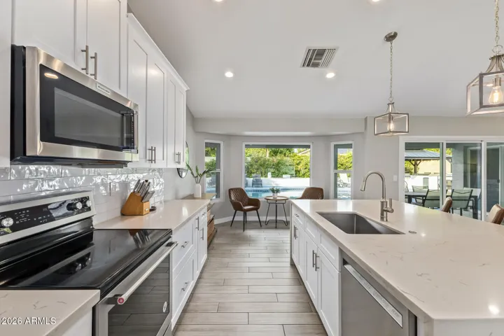 Hang out in the kitchen, watch the game, and the kids swimming.