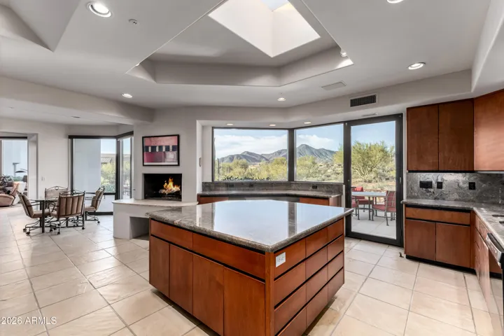 he gourmet kitchen stands as a showpiece, featuring its own fireplace, high-end appliances, granite counters & backsplash, a plethora of cabinetry, a sizable center island, a cozy nook w/wet bar, and a butler's pantry w/built-in appliances.