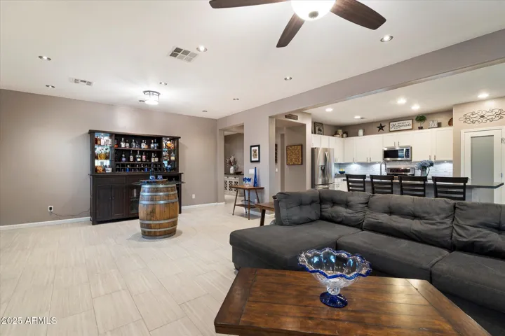 Enjoy open-concept living in this Peoria home, where the expansive living area connects effortlessly to the updated kitchen. Large windows bring in natural light, and upgraded finishes complement the modern design, making this space perfect for everyday living and hosting guests.