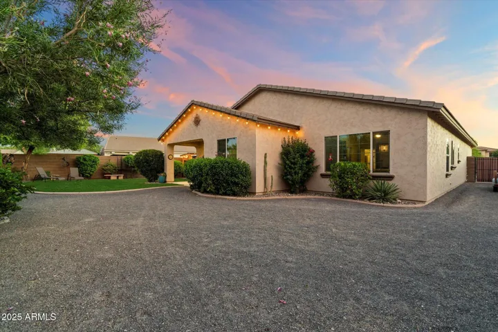 Offering a combination of lush grass and low-maintenance gravel, this backyard provides flexible outdoor space. Mature landscaping and privacy walls enhance the appeal of this Peoria property.