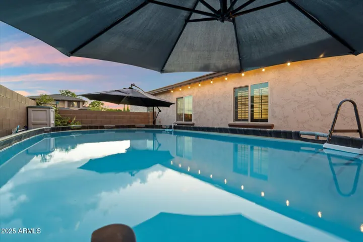 Cool off in the above-ground pool with surrounding patio space and umbrella shade. This well-maintained backyard in Peoria offers a refreshing retreat, perfect for Arizona summers and weekend gatherings.