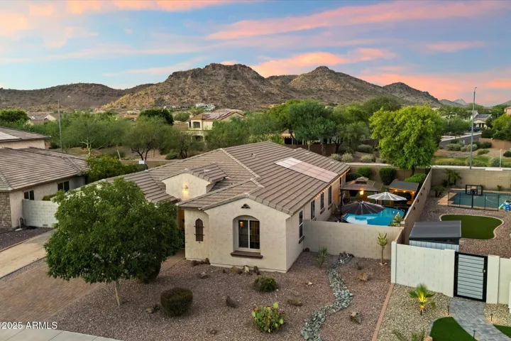 This elevated drone perspective highlights the home’s desirable Peoria location with breathtaking desert mountain views. The backyard retreat includes a pool, pergola seating area, mature trees, and low-maintenance landscaping, creating a perfect blend of relaxation and outdoor entertaining.