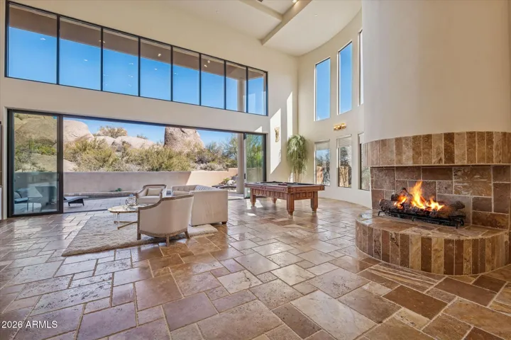 Open stone fireplace creates a warm elevated atmosphere.
