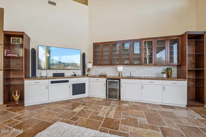 Integrated entertainment center w/beverage fridge and plenty of storage.