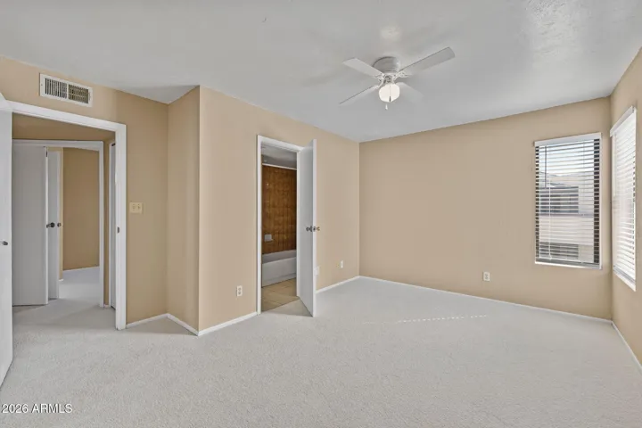 Spacious primary bedroom with attached full bathroom.