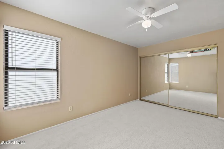 Comfortable primary bedroom with natural light.