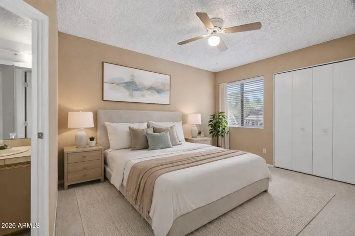 Virtual - Spacious secondary bedroom with new carpet, ceiling fan, and natural light.