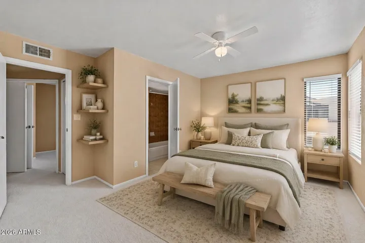 Virtual - Spacious primary bedroom with attached full bathroom.