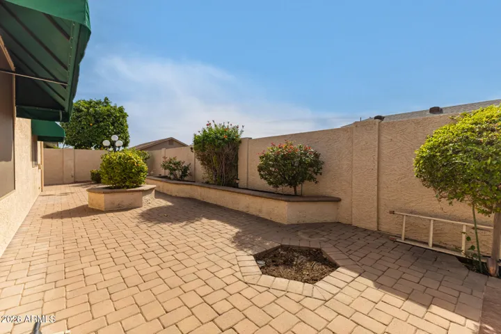 LOW maintenance backyard is 90% hardscaped with select areas for foilage