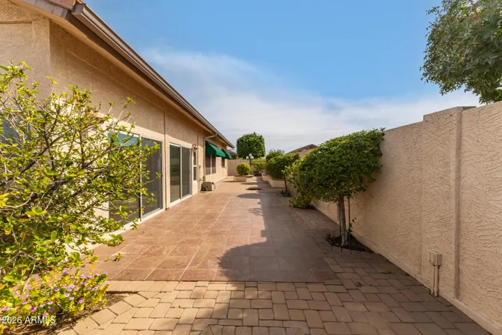 LOW maintenance backyard is 90% hardscaped with select areas for foilage