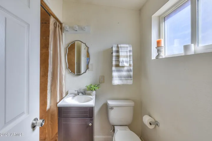 Tiled walk-in shower in primary en-suite bathroom