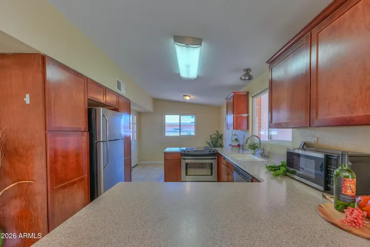 Corian countertops and rich wood cabinetry