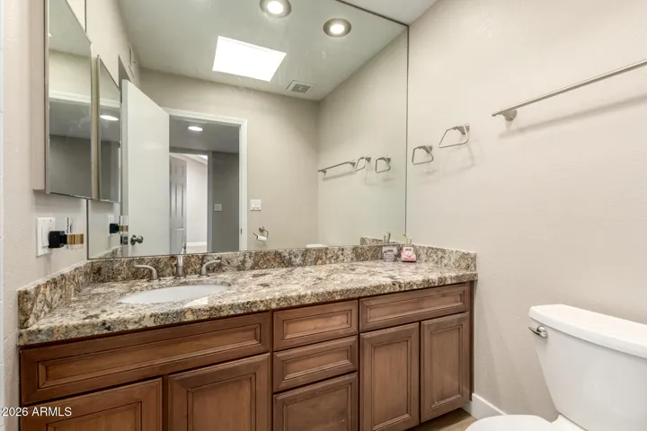 The upstairs bathroom is completed with large mirror and medicine cabinet.